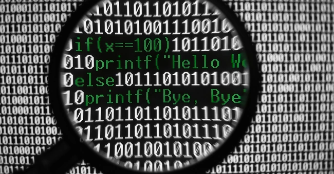 A magnifier glass over code